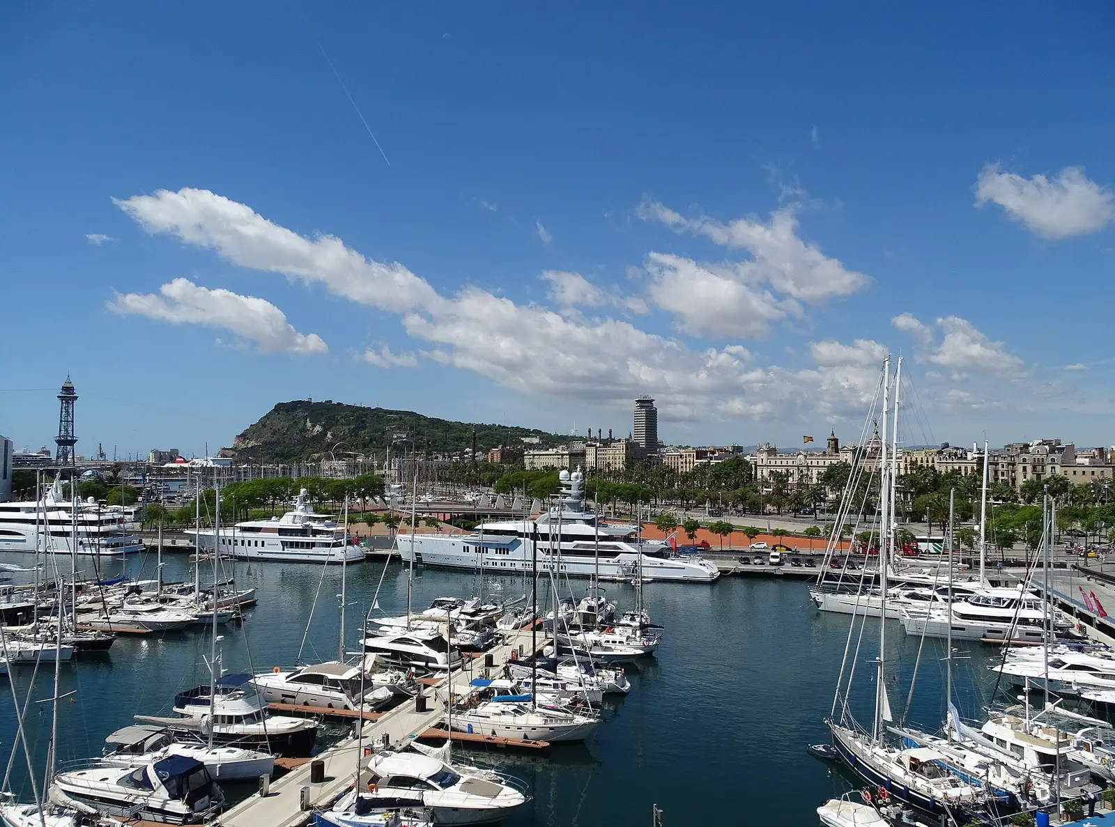 Marina and yachts at Port Vell in Barcelona with Montjuic in the distance