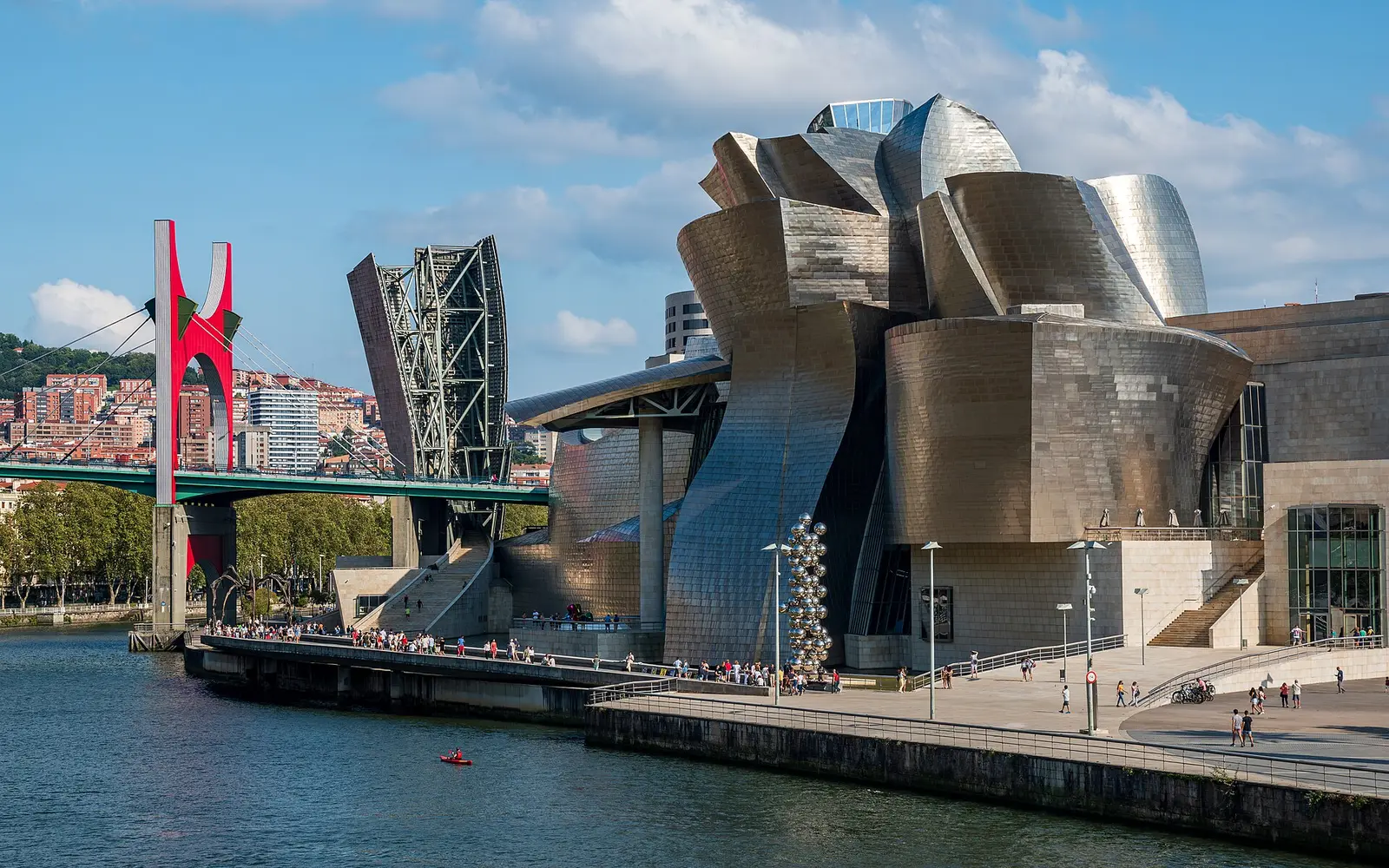 Guggenheim Museum Bilbao beside the river with the red La Salve bridge
