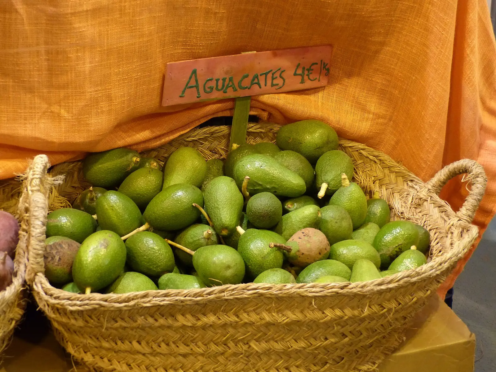 Basket of avocados on a market stall at BioCultura Madrid