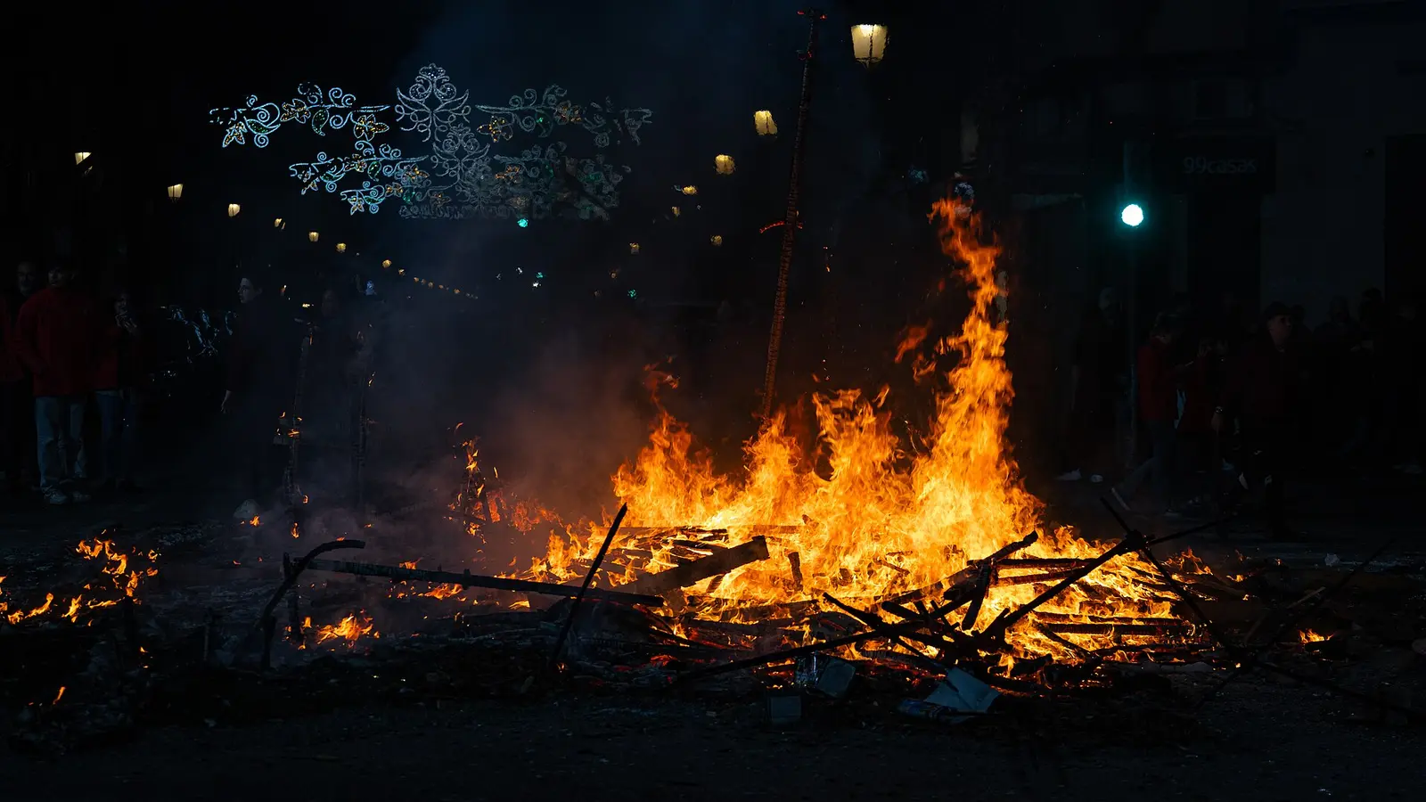 The cremà bonfire burning at night during Las Fallas in Valencia, 2024