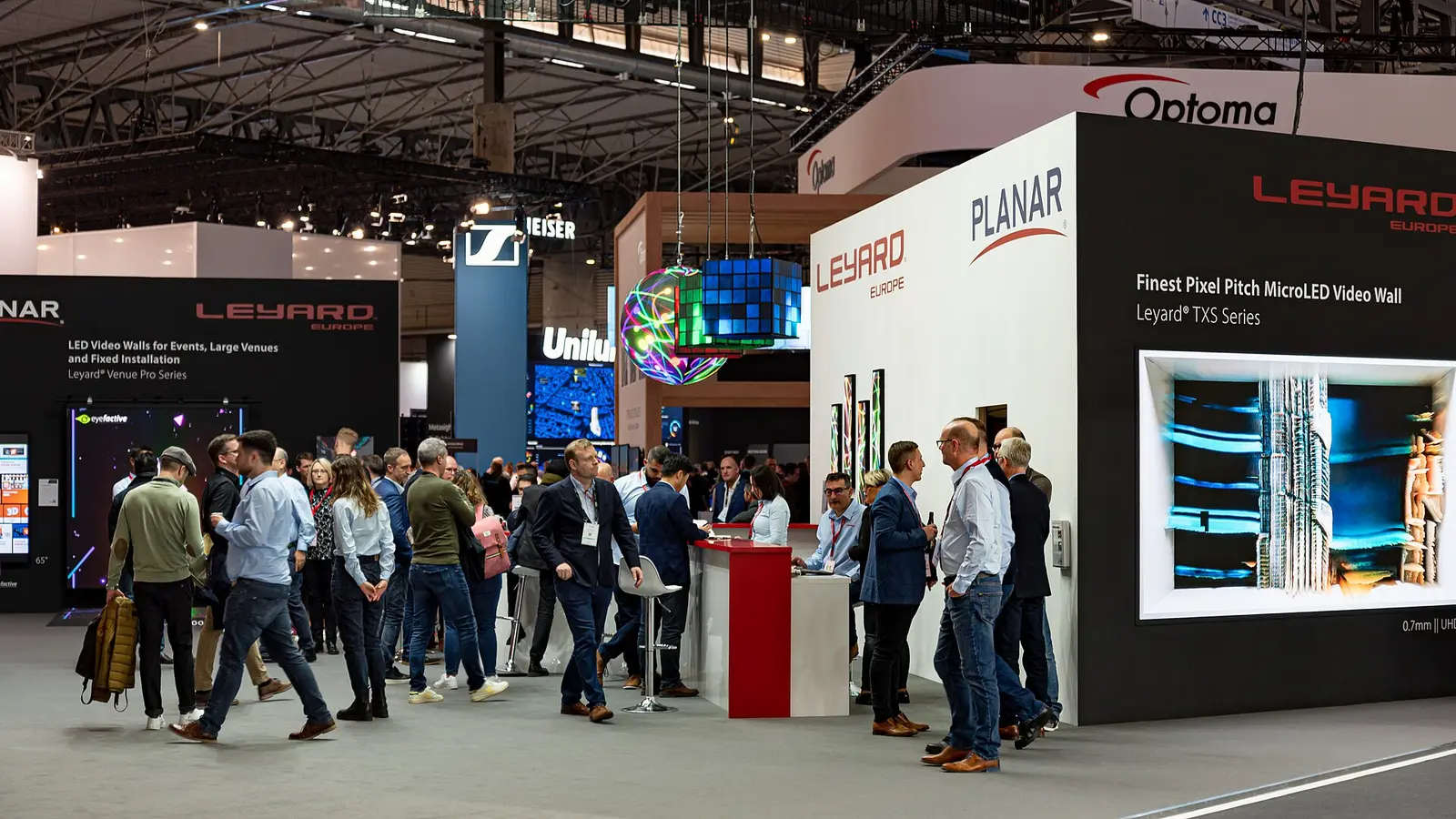 Visitors at exhibitor stands in a hall at Integrated Systems Europe in Barcelona in 2023